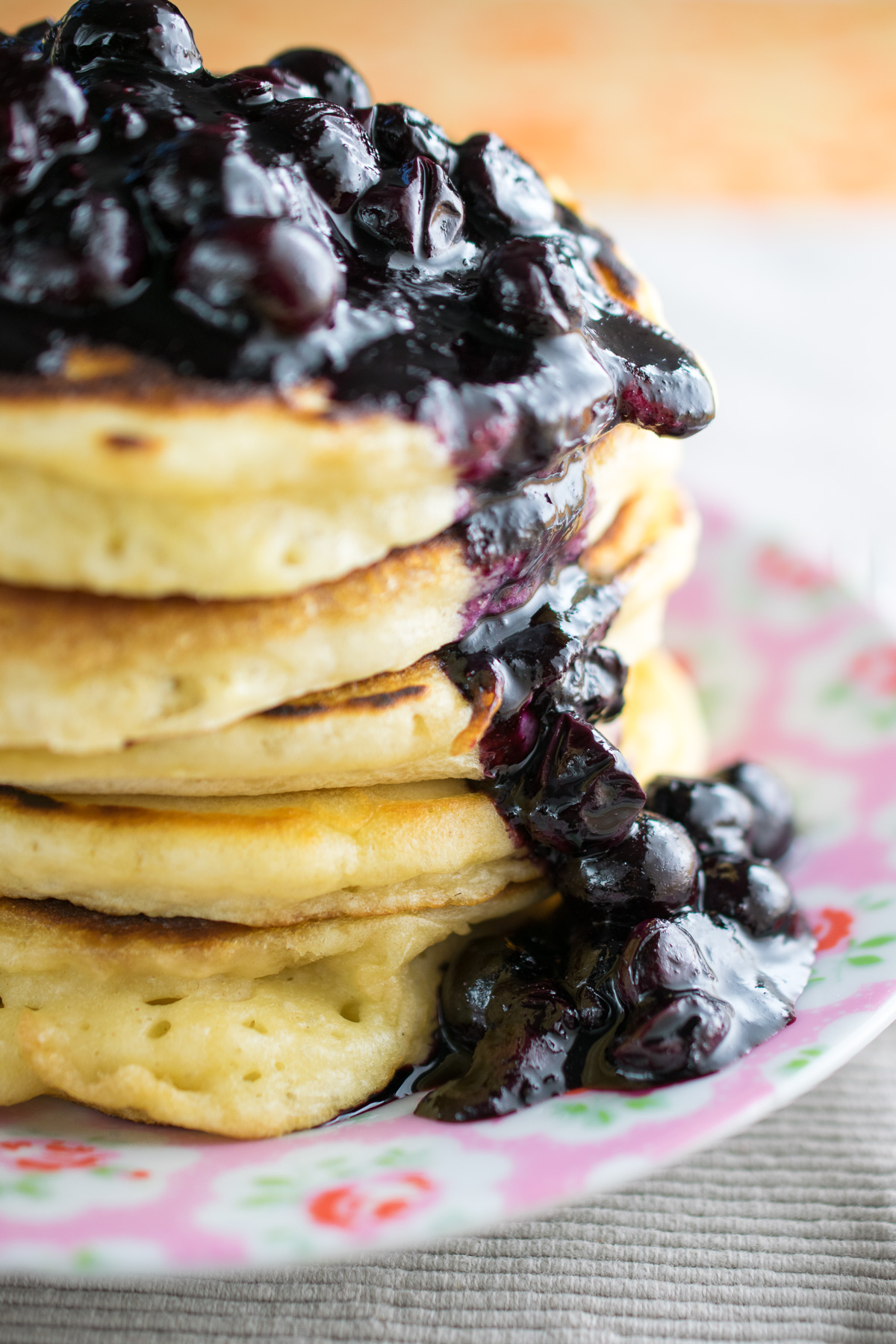 Thick puffy American style pancakes with maple blueberry syrup