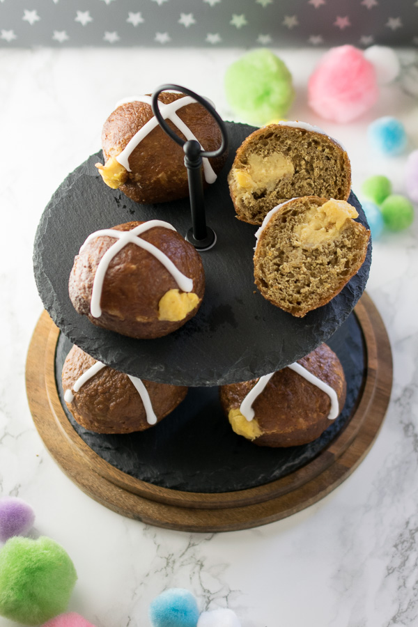 Hot cross donuts - sweet and spicy enriched dough, deep fried before being giving an orange glaze, filled with a citrus scented custard and topped with an icing cross