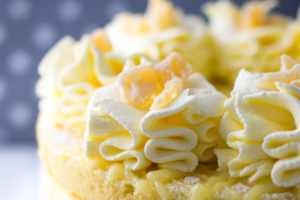 Lemon and almond sponge layered with the lightest lemon cheesecake mousse. Topped with lemon fool (whipped cream with lemon curd folded in) piped rosettes and crystallised pineapple chunks