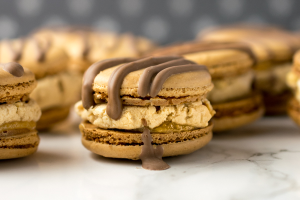 Peanut powder macaron shells filled with homemade nougat (easy peasy), dulce de leche caramel and salted roasted peanuts. All drizzled with milk chocolate to finish! 