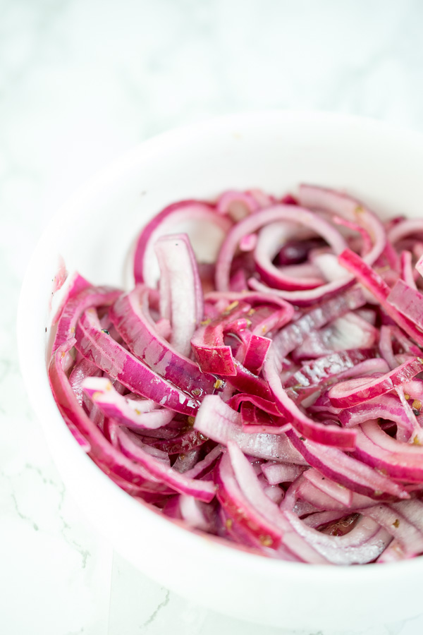 Red onions finely sliced and steeped in lime juice before using as a sort of salad dressing 